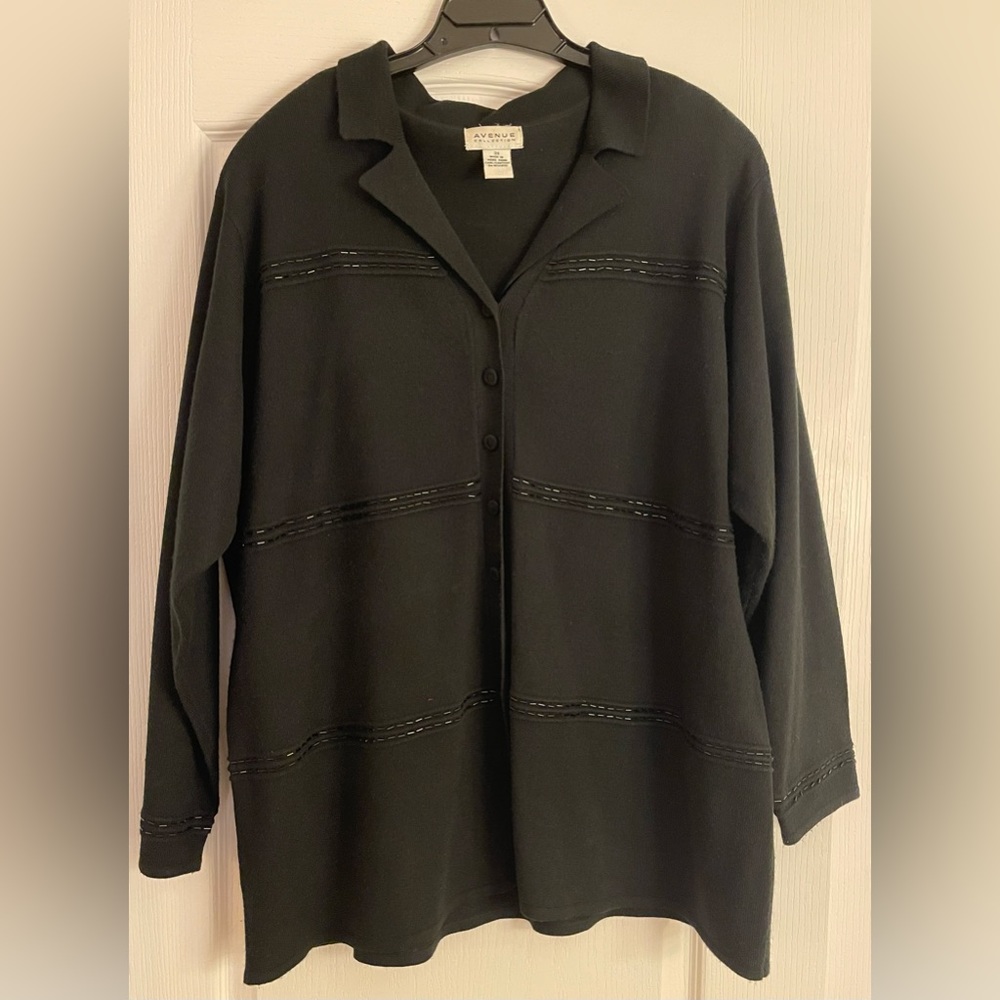 Black, sparkly sweater. Long sleeves. Buttons up the front.